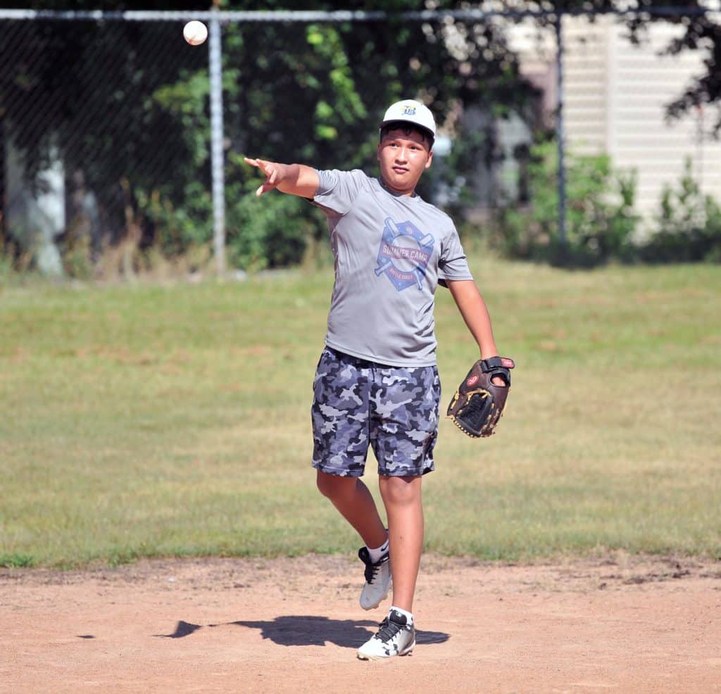 A JP4 participant pitching a baseball