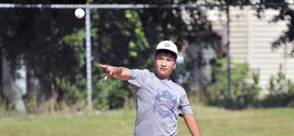 A kid throwing a baseball