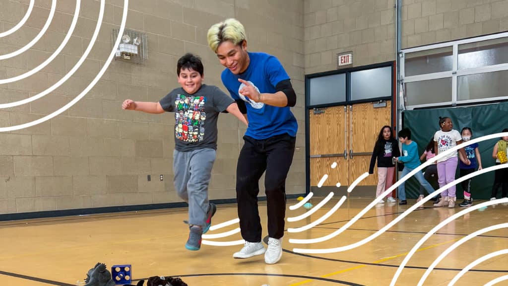 A JP4 mentor plays games in a gymnasium with kids, one of multiple activities encouraged for establishing positive and healthy habits.